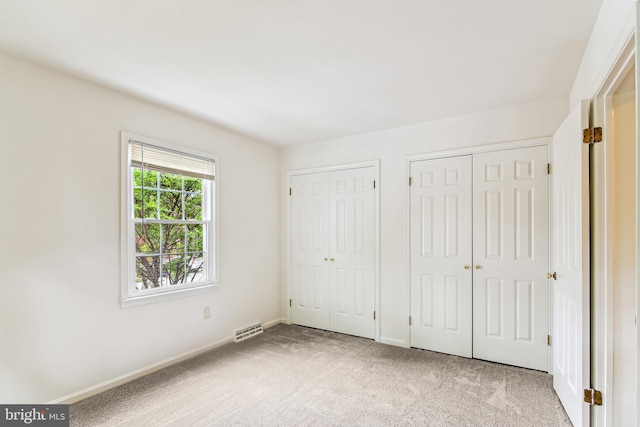 476 Colonial Ridge Ln, Arnold, MD 21012 - unfurnished bedroom featuring multiple closets, carpet flooring, and baseboards