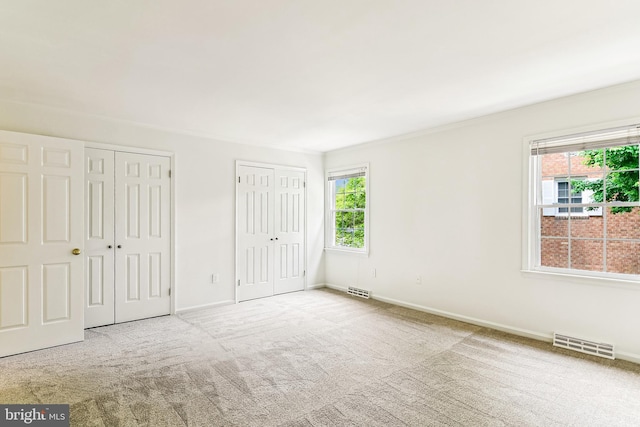 476 Colonial Ridge Ln, Arnold, MD 21012 - unfurnished bedroom with multiple closets, carpet flooring, baseboards, and ornamental molding