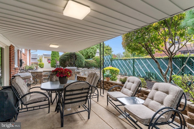 view of patio with a fenced backyard and outdoor dining area