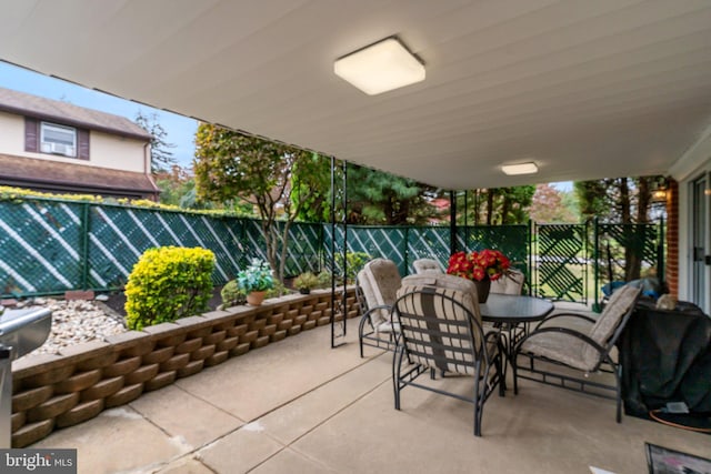 view of patio with outdoor dining area and fence