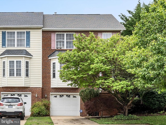 2079 Stoneleigh Dr, Winchester, VA 22601 - view of front of house with an attached garage, brick siding, driveway, and roof with shingles