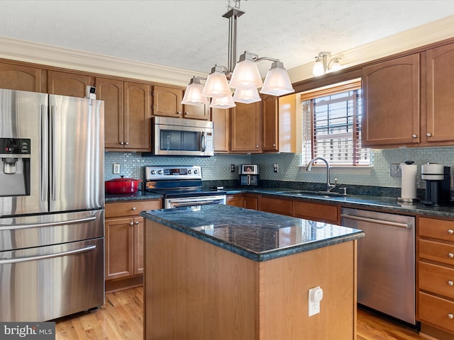 2079 Stoneleigh Dr, Winchester, VA 22601 - kitchen with appliances with stainless steel finishes, a sink, light wood finished floors, a center island, and dark stone counters