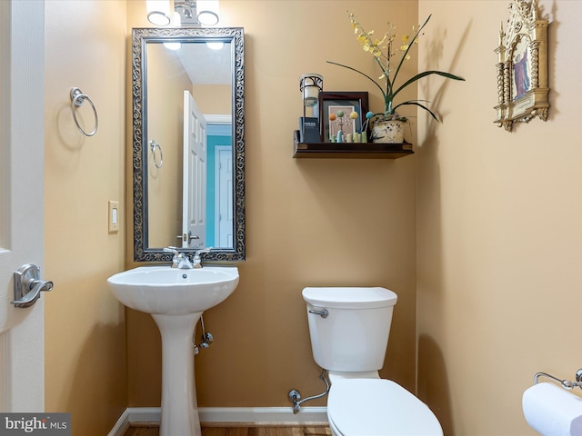 2079 Stoneleigh Dr, Winchester, VA 22601 - half bathroom featuring toilet, a sink, and baseboards