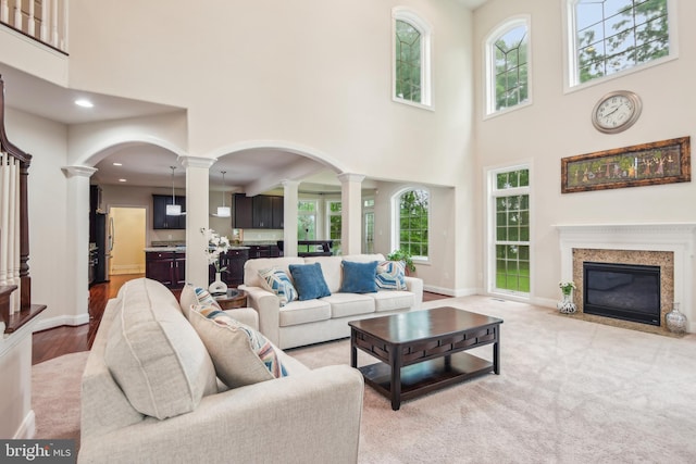 13330 Darnestown Rd, Darnestown, MD 20878 - living area with ornate columns, a towering ceiling, a high end fireplace, baseboards, and recessed lighting