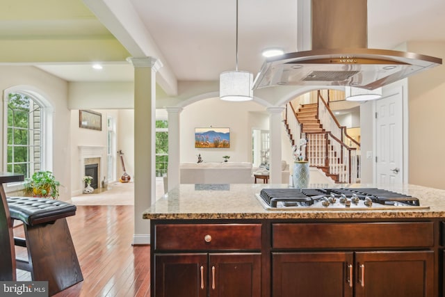 13330 Darnestown Rd, Darnestown, MD 20878 - kitchen featuring stainless steel gas cooktop, open floor plan, ornate columns, and island exhaust hood