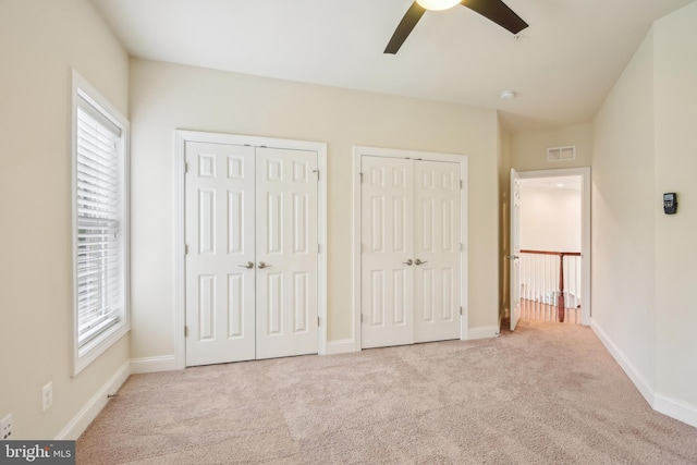 13330 Darnestown Rd, Darnestown, MD 20878 - unfurnished bedroom with two closets, carpet, multiple windows, and baseboards