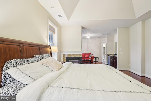 13330 Darnestown Rd, Darnestown, MD 20878 - bedroom with dark wood finished floors, baseboards, a glass covered fireplace, and vaulted ceiling