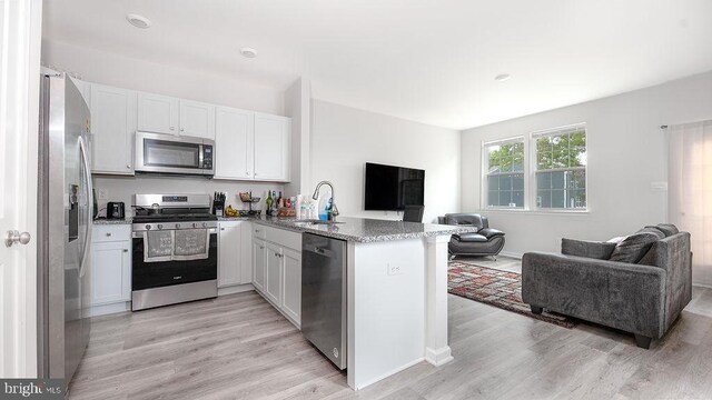 1214 Peterson Way, Absecon, NJ 08201 - kitchen with appliances with stainless steel finishes, open floor plan, a sink, and a peninsula