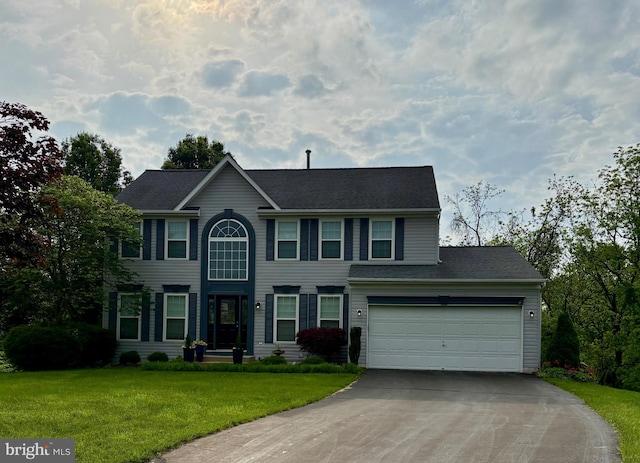 colonial house featuring driveway, a front lawn, a shingled roof, and a garage