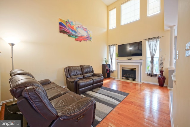 251 Starboard Way, Mount Laurel, NJ 08054 - living room with wood finished floors, decorative columns, a towering ceiling, and a fireplace with flush hearth