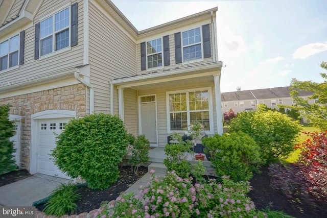 251 Starboard Way, Mount Laurel, NJ 08054 - doorway to property with a garage, covered porch, and stone siding