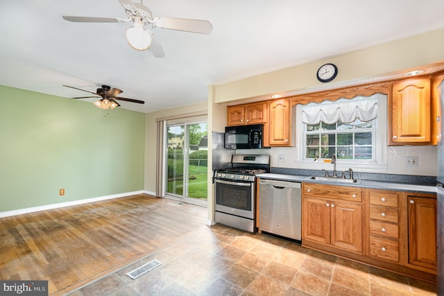 9005 Fieldchat Rd, Baltimore, MD 21236 - kitchen featuring stainless steel appliances, a sink, backsplash, ceiling fan, and baseboards
