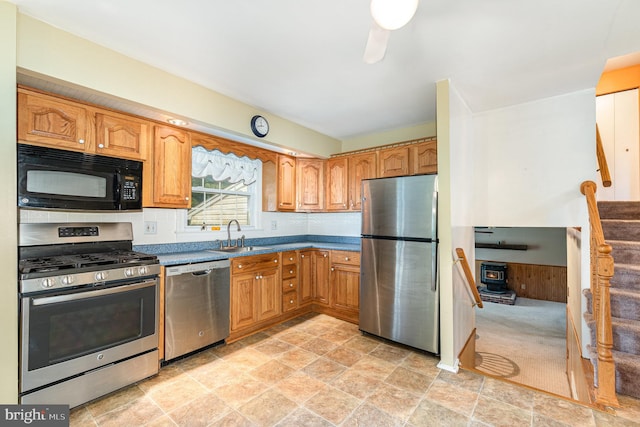 9005 Fieldchat Rd, Baltimore, MD 21236 - kitchen with stainless steel appliances, a sink, stone finish flooring, and brown cabinetry