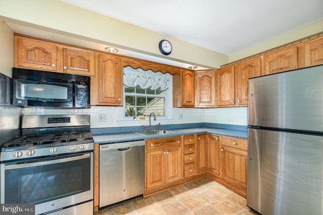 9005 Fieldchat Rd, Baltimore, MD 21236 - kitchen featuring stainless steel appliances, a sink, brown cabinets, and backsplash