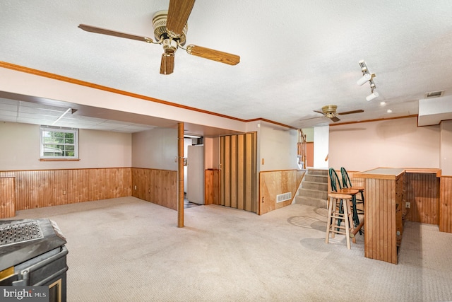 9005 Fieldchat Rd, Baltimore, MD 21236 - basement with a ceiling fan, a wainscoted wall, wood walls, carpet flooring, and stairway