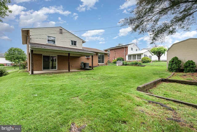 9005 Fieldchat Rd, Baltimore, MD 21236 - rear view of property featuring a patio, brick siding, a yard, and cooling unit