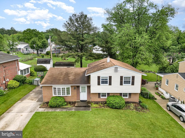 9005 Fieldchat Rd, Baltimore, MD 21236 - split level home featuring brick siding, a front lawn, and concrete driveway