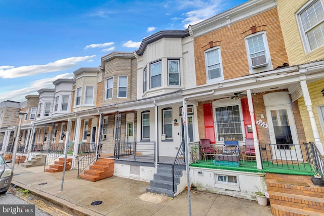 multi unit property featuring covered porch and a residential view