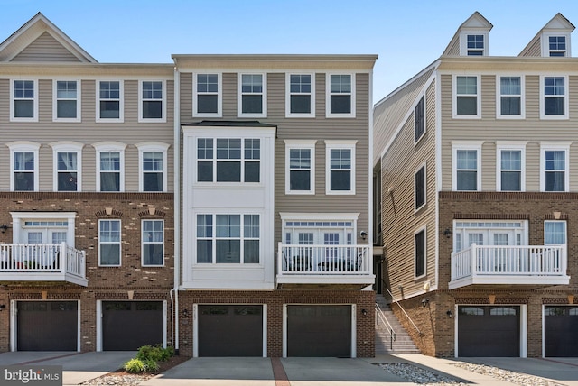 42189 Shorecrest Ter, Aldie, VA 20105 - townhome / multi-family property featuring a garage, brick siding, and driveway