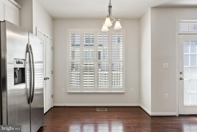 42189 Shorecrest Ter, Aldie, VA 20105 - unfurnished dining area featuring a chandelier, dark wood-style floors, and baseboards