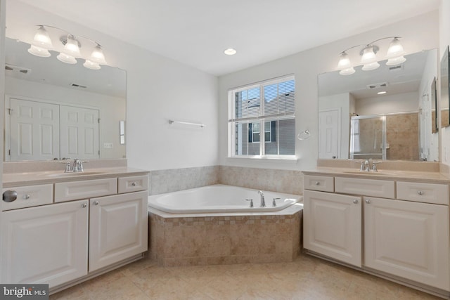 42189 Shorecrest Ter, Aldie, VA 20105 - full bathroom with two vanities, tile patterned floors, a bath, and a shower stall