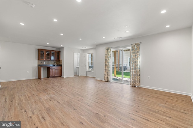42189 Shorecrest Ter, Aldie, VA 20105 - unfurnished living room featuring baseboards, light wood-style floors, and recessed lighting
