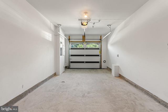 42189 Shorecrest Ter, Aldie, VA 20105 - garage featuring baseboards and a garage door opener