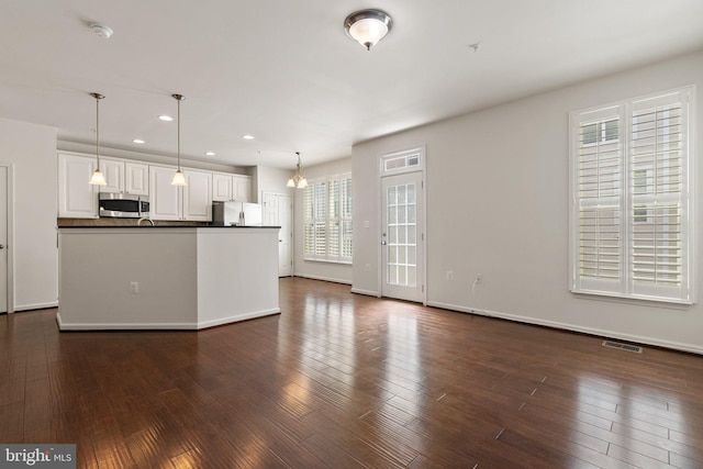 42189 Shorecrest Ter, Aldie, VA 20105 - kitchen with stainless steel microwave, freestanding refrigerator, dark countertops, recessed lighting, and white cabinets