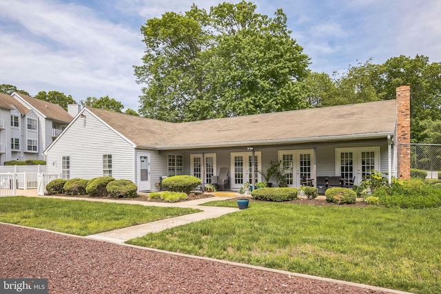 ranch-style home with french doors and a chimney