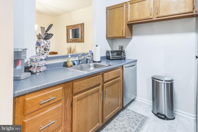 kitchen with a sink, dishwasher, brown cabinets, baseboards, and light tile patterned floors