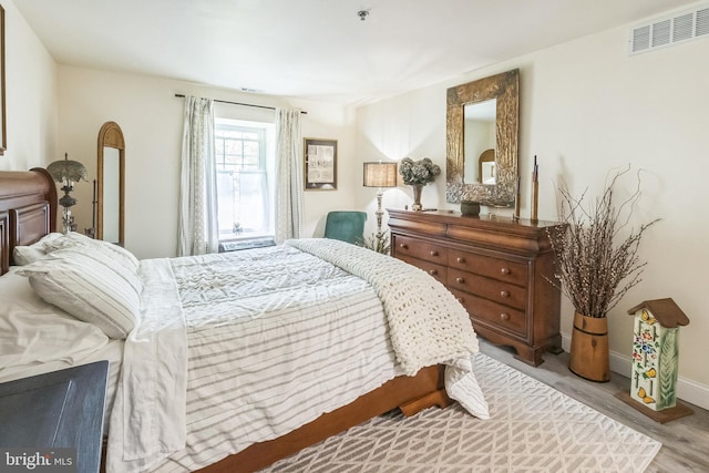 bedroom featuring wood finished floors and baseboards