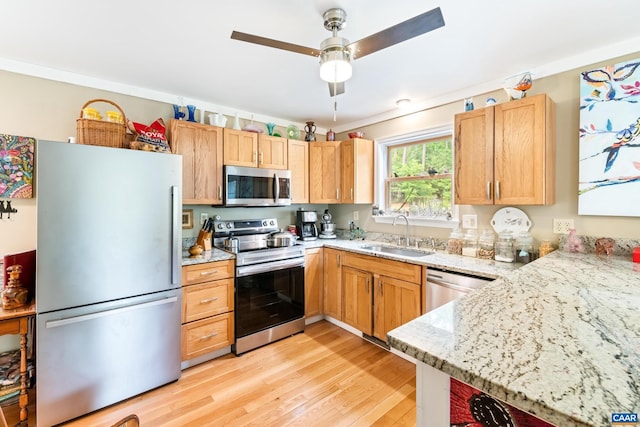 686 Snow Mountain Rd, Stanardsville, VA 22973 - kitchen featuring stainless steel appliances, a sink, light wood-style floors, light stone counters, and ceiling fan