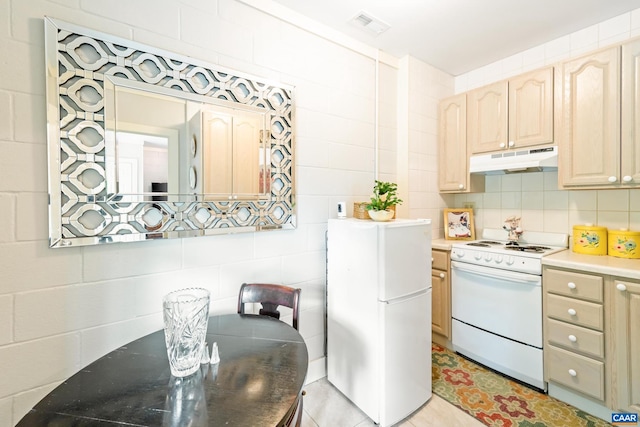686 Snow Mountain Rd, Stanardsville, VA 22973 - kitchen featuring white appliances, under cabinet range hood, backsplash, light brown cabinets, and tile walls