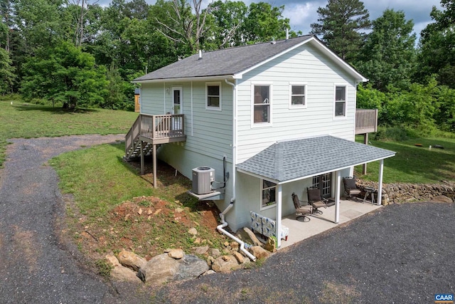 686 Snow Mountain Rd, Stanardsville, VA 22973 - back of house featuring roof with shingles, a lawn, central AC unit, and a patio
