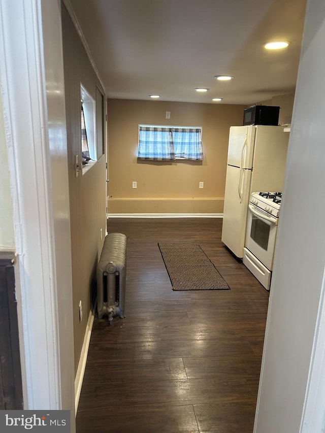 4415 Elizabeth St, Philadelphia, PA 19124 - kitchen featuring white appliances, dark wood-style flooring, baseboards, recessed lighting, and radiator