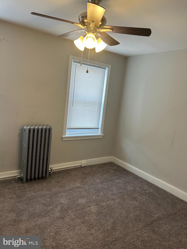 4415 Elizabeth St, Philadelphia, PA 19124 - unfurnished room featuring radiator heating unit, ceiling fan, dark colored carpet, and baseboards