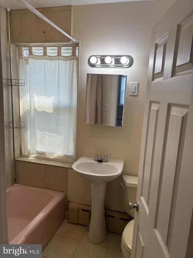4415 Elizabeth St, Philadelphia, PA 19124 - bathroom featuring toilet, tile patterned flooring, a tub to relax in, and a shower