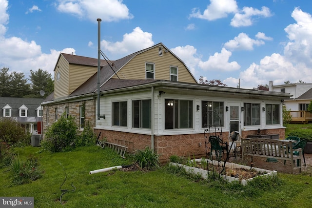 208 Clark Rd, Hershey, PA 17033 - rear view of property with a lawn, central air condition unit, a garden, and brick siding