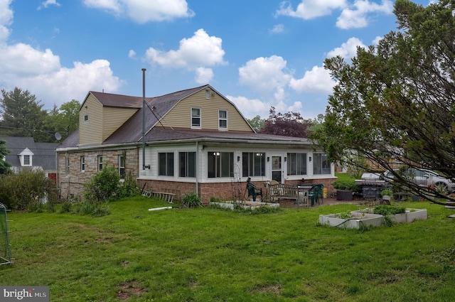 208 Clark Rd, Hershey, PA 17033 - rear view of property featuring a lawn, a vegetable garden, brick siding, and stone siding