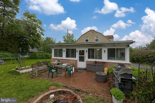 208 Clark Rd, Hershey, PA 17033 - back of house with a yard, a patio, a gambrel roof, a sunroom, and a vegetable garden
