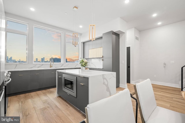 2201 E Somerset St Unit B3Upper, Philadelphia, PA 19134 - kitchen with stainless steel microwave, light wood-style flooring, modern cabinets, plenty of natural light, and recessed lighting