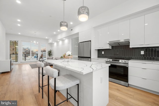 2201 E Somerset St Unit B3Lower, Philadelphia, PA 19134 - kitchen with appliances with stainless steel finishes, under cabinet range hood, modern cabinets, a kitchen breakfast bar, and recessed lighting