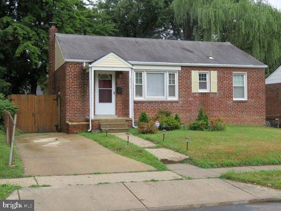 view of front facade with brick siding and a chimney