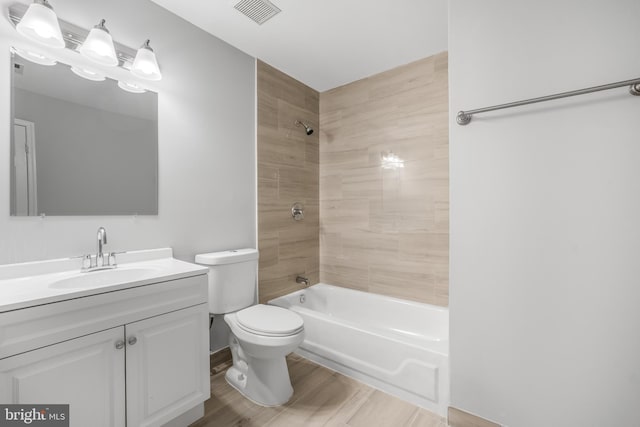 full bath with toilet, wood finished floors, shower / bathtub combination, and vanity