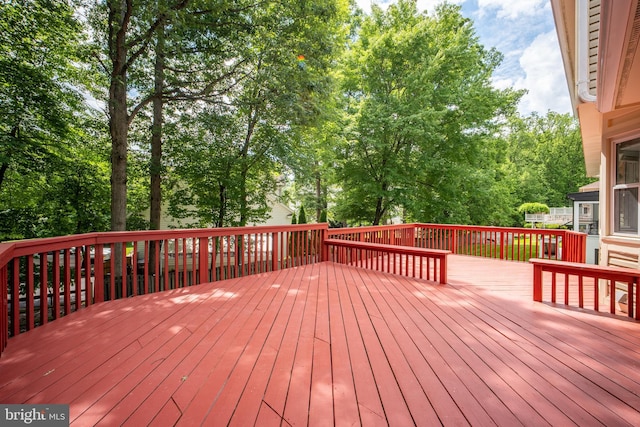 deck featuring view of wooded area