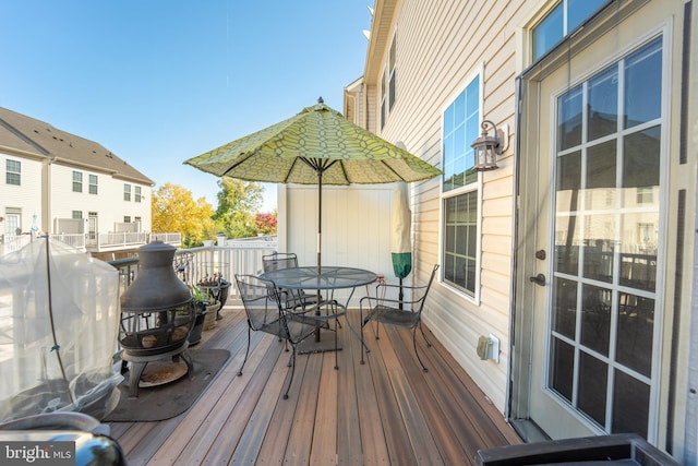 wooden deck featuring outdoor dining space