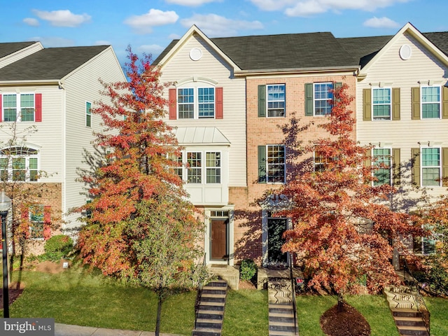 townhome / multi-family property with brick siding
