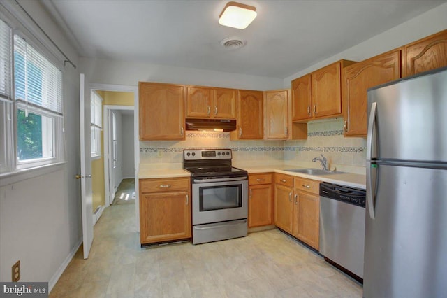 102 Andover Ct, Frederick, MD 21702 - kitchen with stainless steel appliances, a sink, under cabinet range hood, light countertops, and decorative backsplash