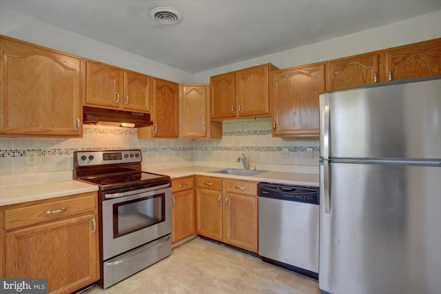 102 Andover Ct, Frederick, MD 21702 - kitchen featuring stainless steel appliances, under cabinet range hood, a sink, light countertops, and backsplash