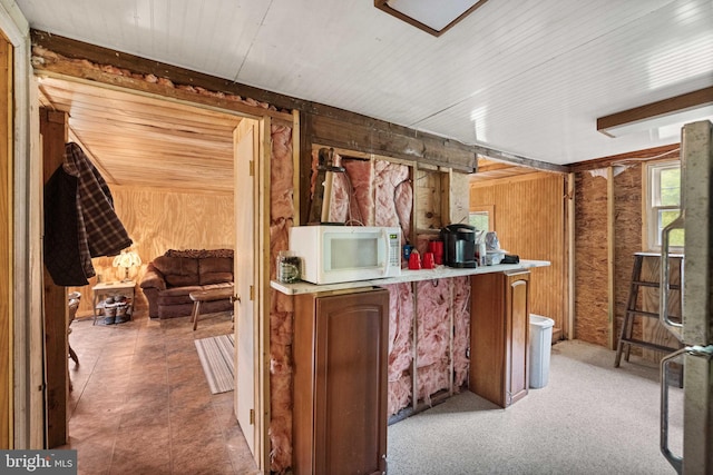 1939 Old Reading Rd Lot 67, 95, Catawissa, PA 17820 - kitchen with white microwave, wood walls, wooden ceiling, and light countertops